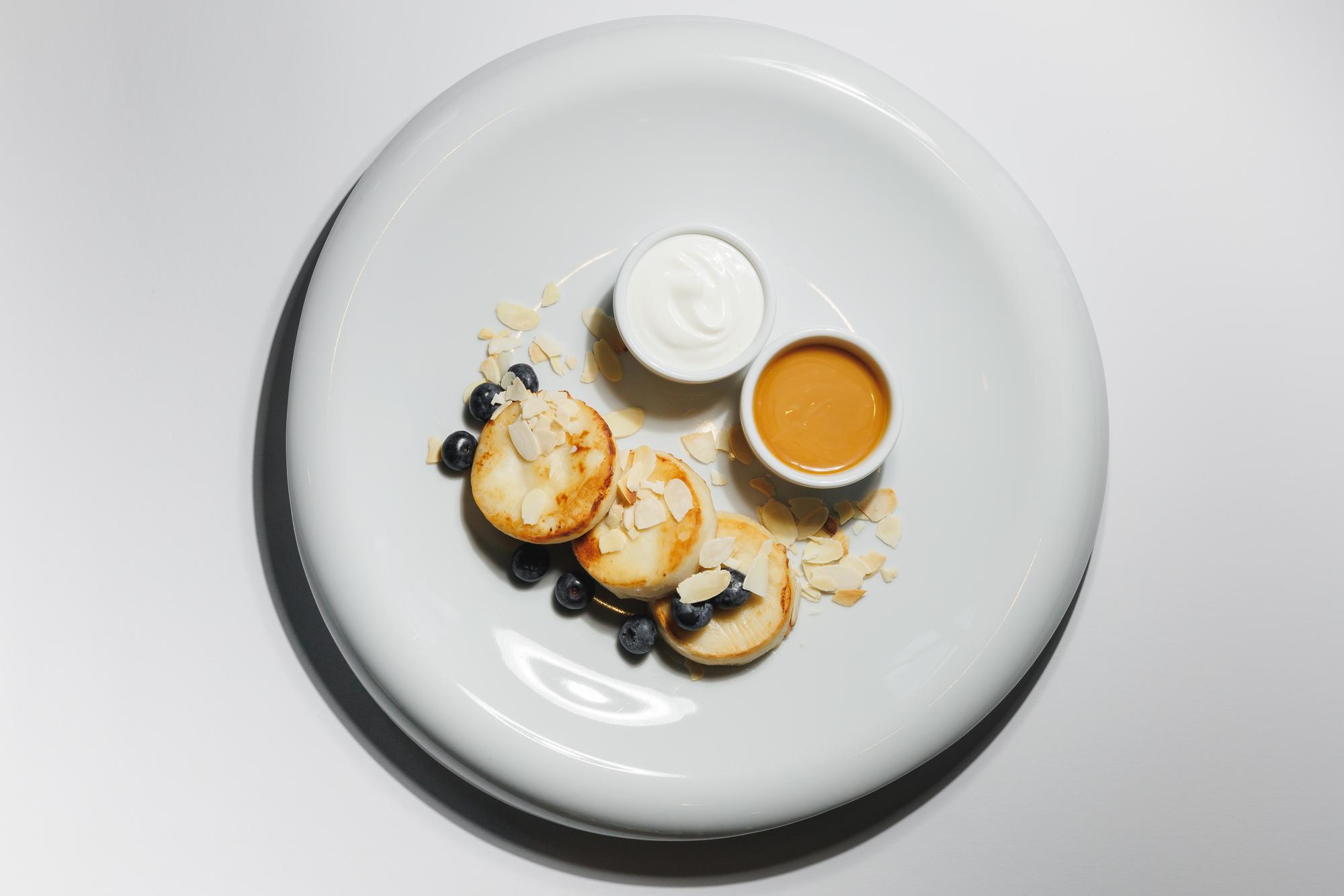 Warm studio kitchen with plated tasting sequence