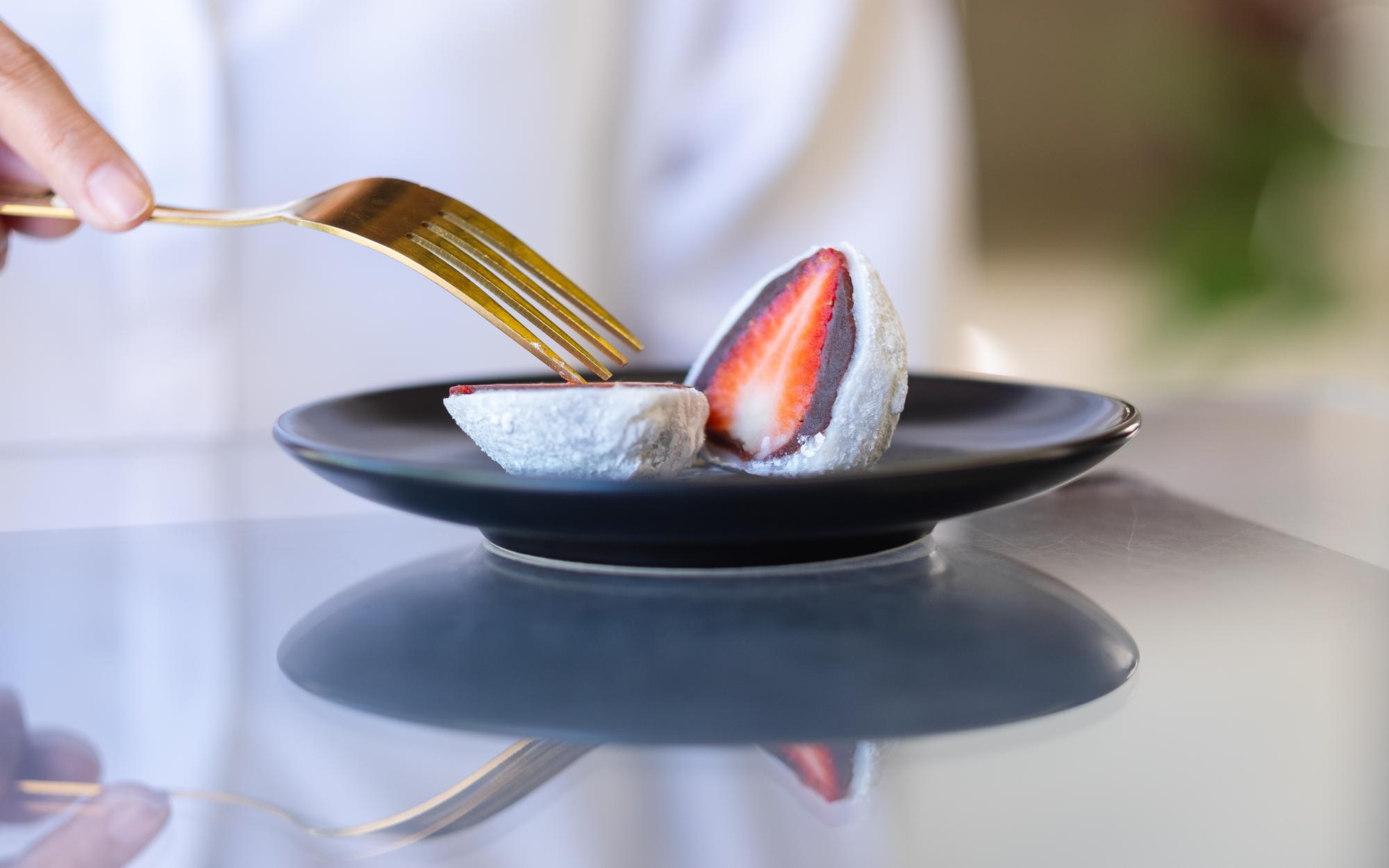 Chef arranging a plated tasting menu on ceramic plates